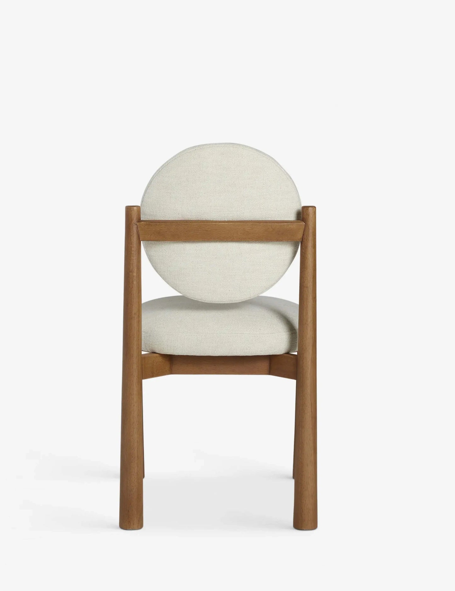 Back view of the Badr Dining Chair highlighting the curved wooden frame and cushioned backrest.