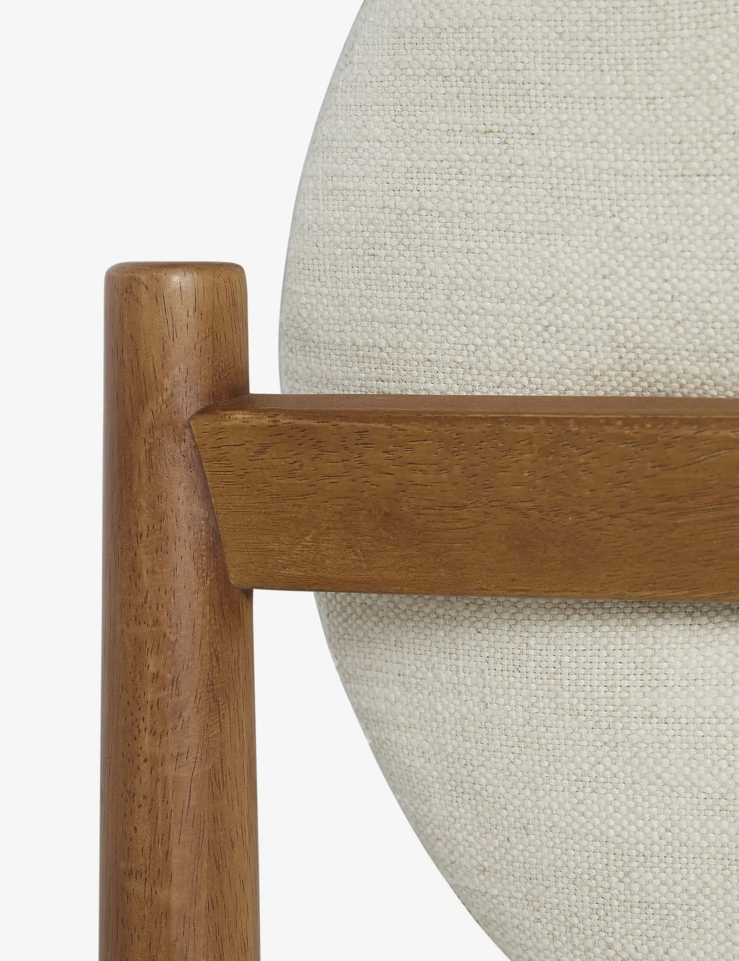 Close-up of the Badr Dining Chair’s upholstered seat and wood frame, showcasing fine craftsmanship.