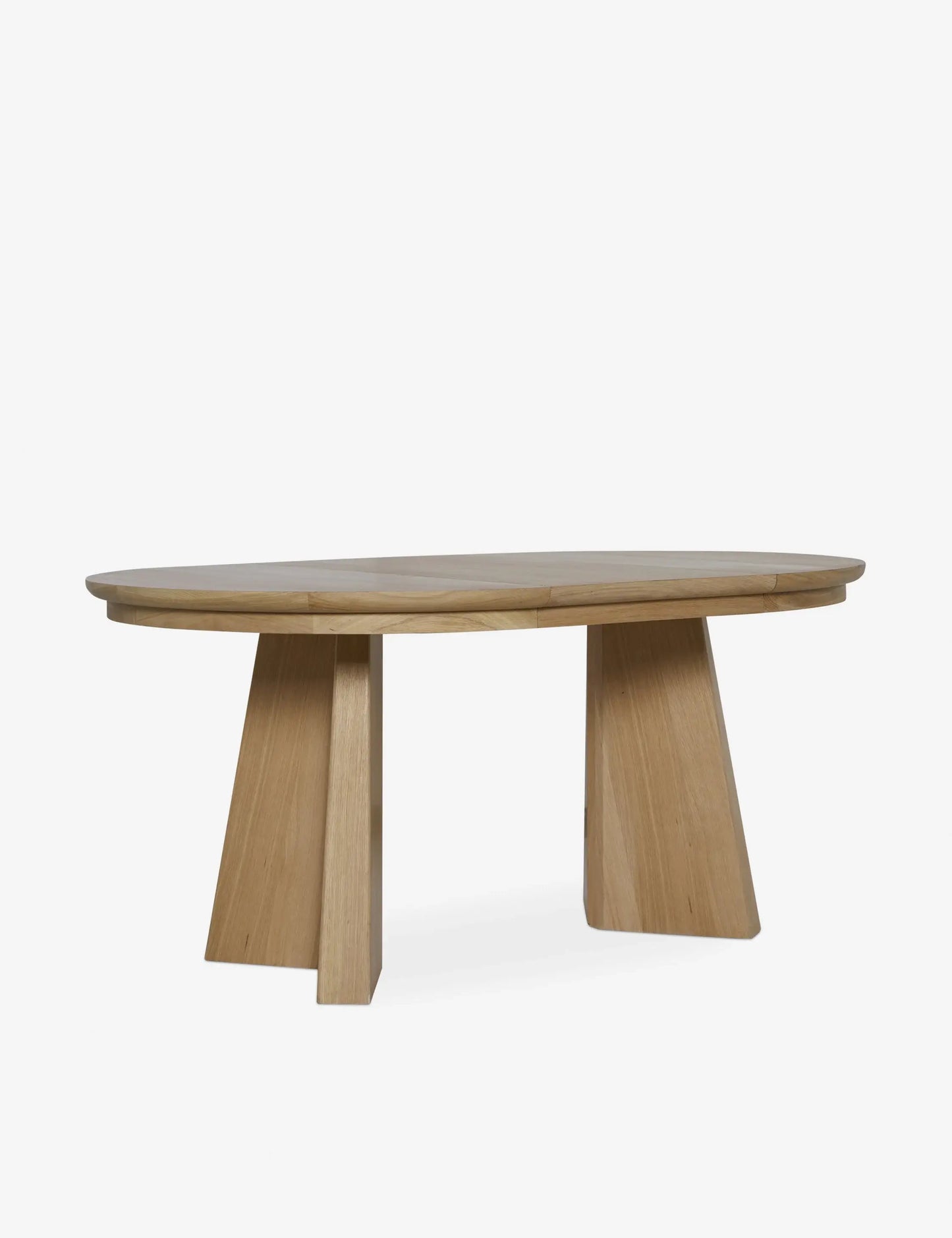 Ghareeb dining table extended to an elegant oval shape, comfortably seating six, crafted from solid oak wood.