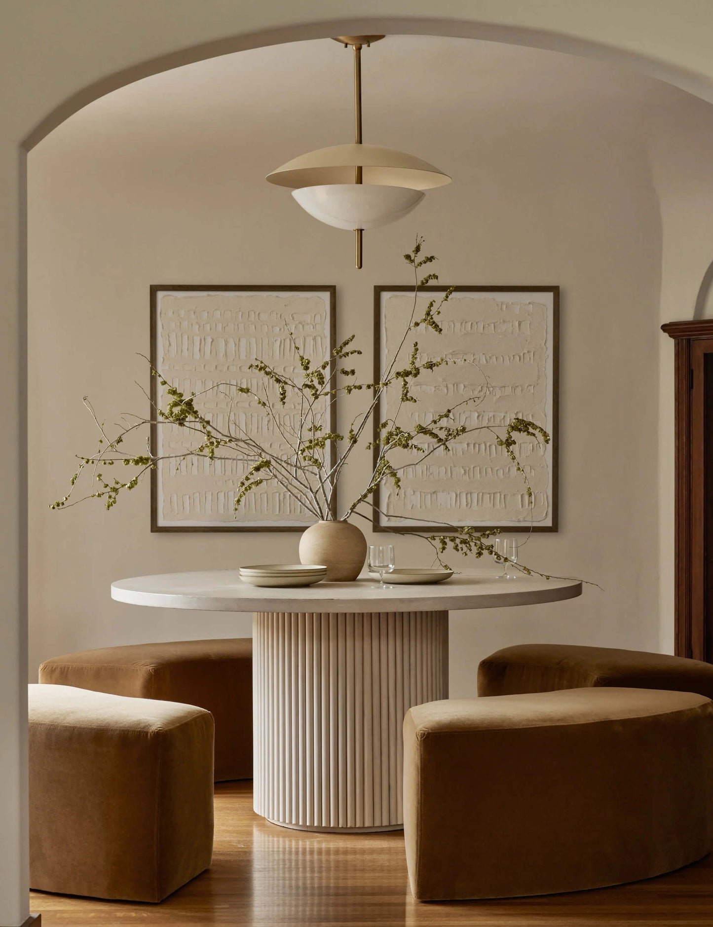 Luxury dining room with Meis round dining table and velvet chairs.