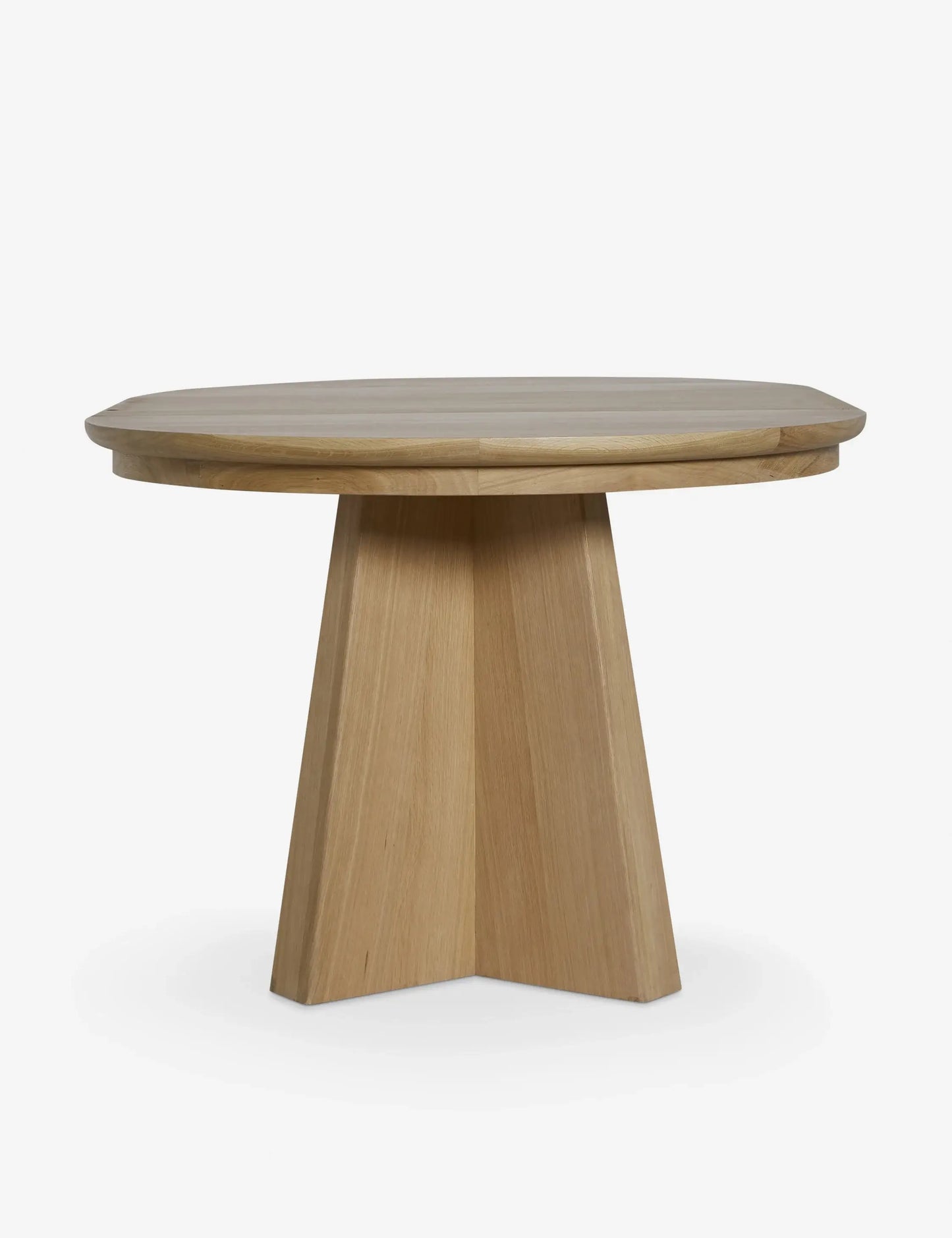 Angular wooden legs of the Ghareeb extendable dining table, supporting its transformation from round to oval.