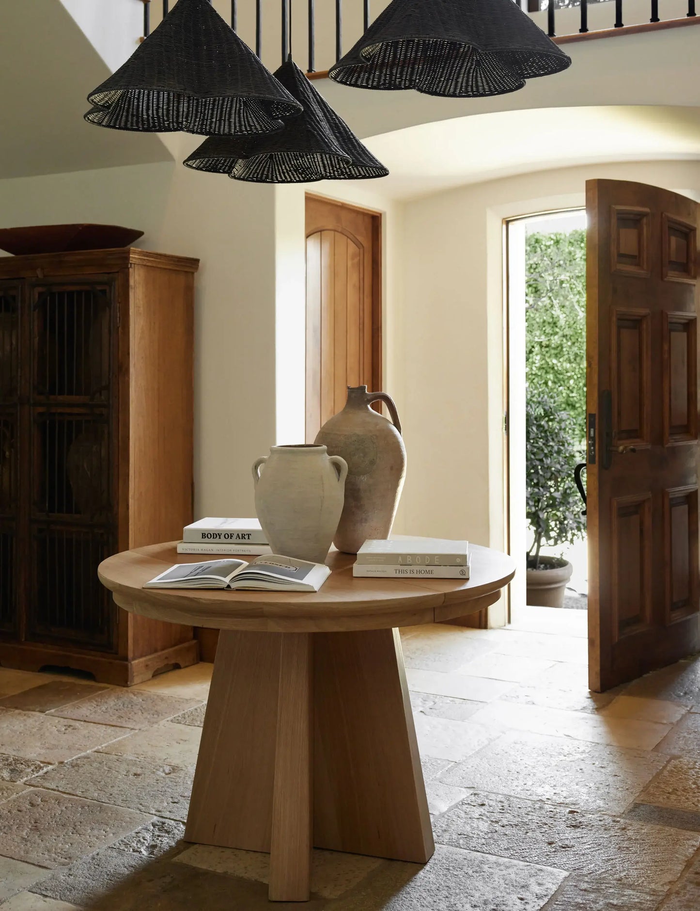 Versatile Ghareeb oak wood dining table styled as an entryway table, showcasing its minimalist and modern design.