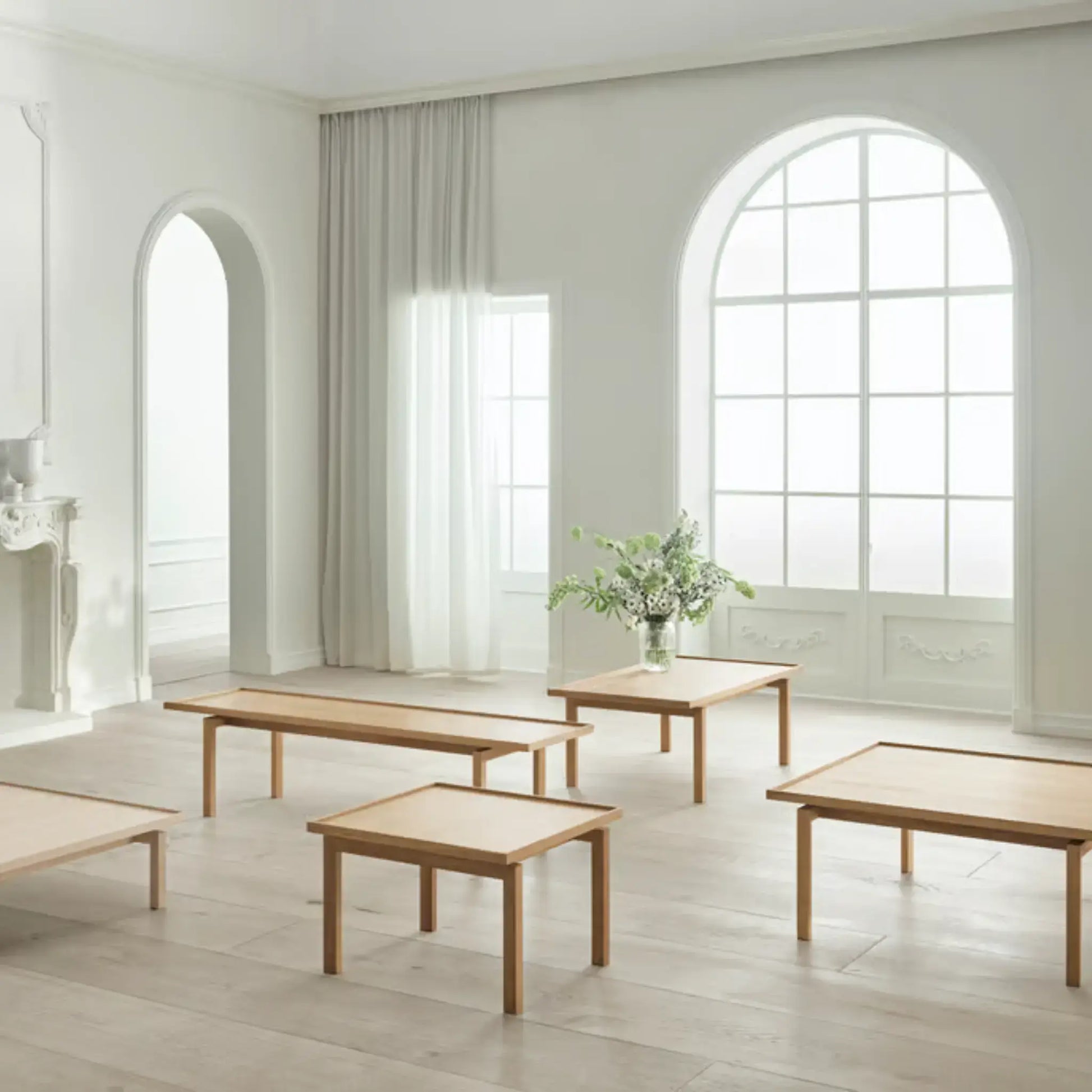 Multiple Raha Lounge Tables in different sizes displayed in a serene minimalist interior